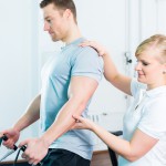 Physiotherapist excercising patient in practice